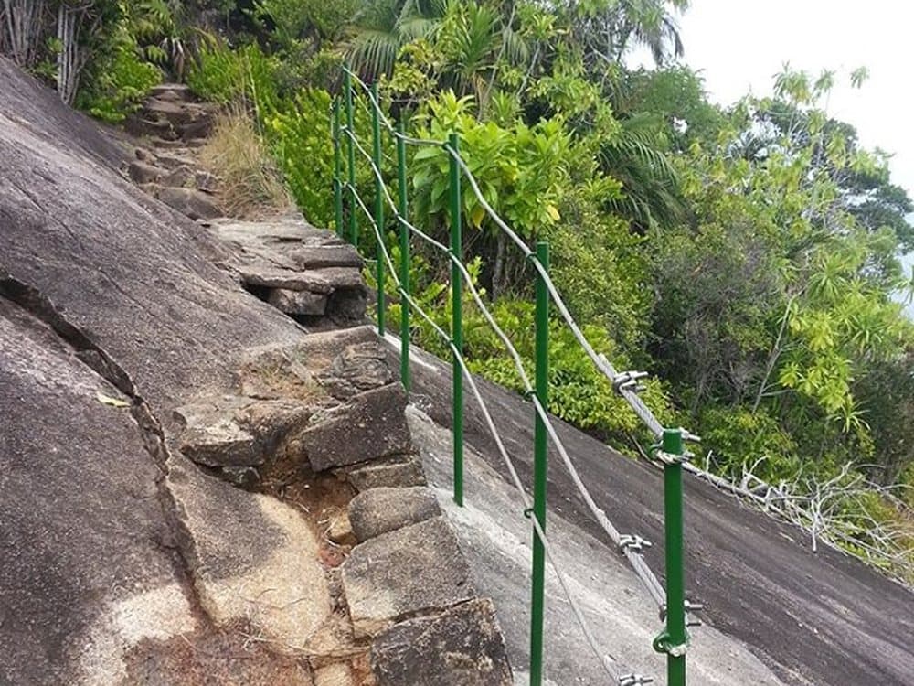 The granite steps and handrail on the trail to Anse Major